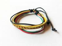 Bőr karkötő fém pöttyökkel sárga